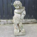 A reconstituted stone garden figure of a cherub,