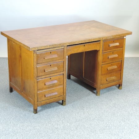 An early 20th century oak pedestal desk,