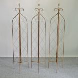 A set of three folding lattice garden spires,