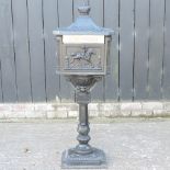 A black painted cast iron pillar post box,