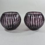 A pair of purple overlaid glass vases,