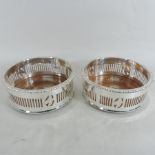A pair of silver plated bottle coasters,