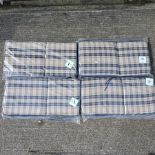 A set of four blue garden furniture cushions