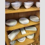 A collection of white glazed and enamelled table wares