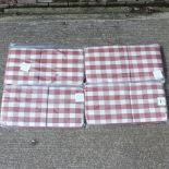A set of four red garden furniture cushions