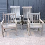 A pair of teak garden armchairs,