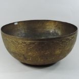A Tibetan singing bowl, or bell, with engraved decoration,