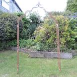 A rusted metal garden arch,