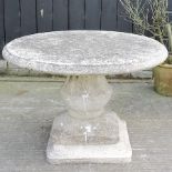 A circular reconstituted stone garden table, 97cm diameter,