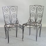 A pair of wrought iron garden chairs