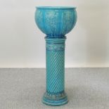 A 19th century Burmantofts blue glazed pottery jardiniere, relief decorated with panels of flowers,