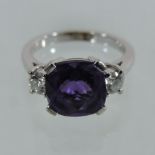 An 18 carat white gold amethyst and diamond three stone ring,