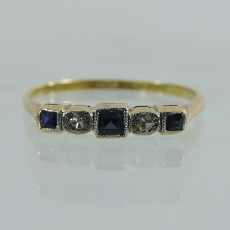 An 18 carat gold sapphire and diamond five stone ring