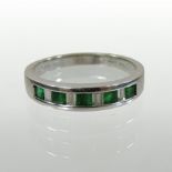 An 18 carat white gold channel set emerald and diamond half hoop eternity ring,