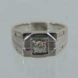 An 18 carat white gold and diamond gentleman's ring, the central stone approximately 0.