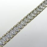A 14 carat gold and diamond set tennis bracelet