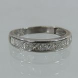 A 9 carat white gold half hoop eternity ring, set with ten princess cut diamonds, approximately 1.