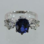 An impressive 18 carat white gold three stone sapphire and diamond ring,