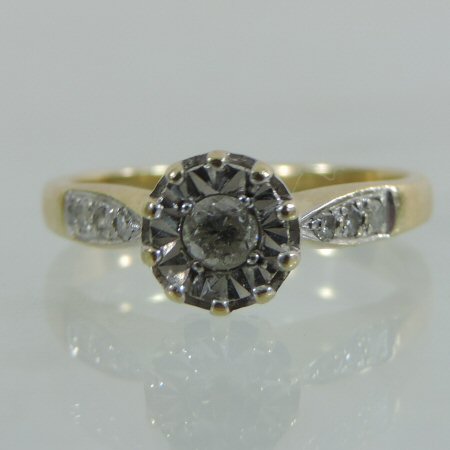 An 18 carat gold illusion set diamond solitaire ring, approximately 0.