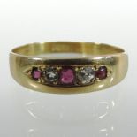 An 18 carat gold ruby and diamond five stone ring