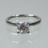 A platinum and diamond solitaire ring, with a crossover setting, approximately 0.