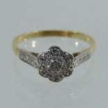 An 18 carat gold and platinum set diamond daisy set ring,