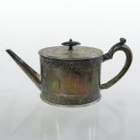 A George III silver teapot, of oval shape, with an ebonised handle,