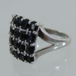 A 9 carat white gold square set sapphire and diamond cluster ring,