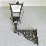 A cast iron lantern, with an ornate bracket by Candela lighting,