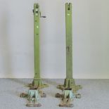 A pair of Ed Ayres green painted tennis net posts and fittings,