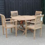 A teak circular garden table, 114cm,