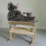 A metal working lathe, on a wooden stand, 104cm,