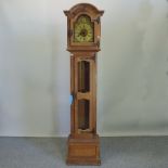 An oak cased longcase clock, having a three train movement, with Westminster chimes,