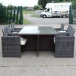 A rattan glass top garden table, 185 x 125cm, together with a set of six chairs,