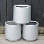 A set of three silver painted garden pots,