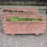 A pair of reconstituted stone terracotta coloured garden troughs,