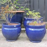 A collection of four blue glazed garden pots,