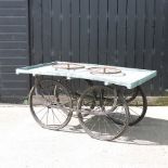 A blue painted wooden market vendor's cart, on iron wheels,