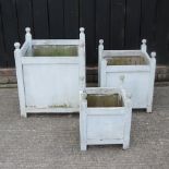 A graduated set of three painted wooden planters,