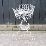 An early 20th century white painted metal wirework plant stand,