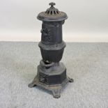 A French black painted iron stove,