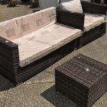 A rattan garden three seater sofa, with loose cushions, 135cm,