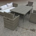 A rattan garden set, comprising a dining table, 161 x 100cm, a two seater sofa,