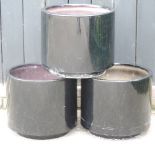 A set of three black garden pots,