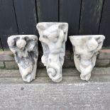 A collection of three carved stone figural wall brackets,