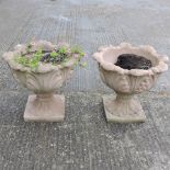 A pair of reconstituted stone garden urns,