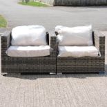 A pair of rattan garden armchairs,