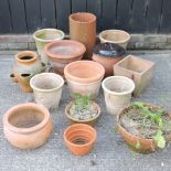 A collection of various terracotta garden pots,