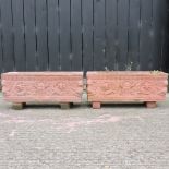 A pair of reconstituted stone terracotta coloured planters,