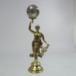 An early 20th century brass miniature ball clock, in the form of a lady,